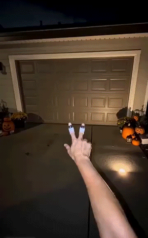 Projector rings shining shapes onto a driveway at night