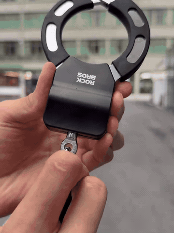 Dual-cuff bike and scooter lock in use