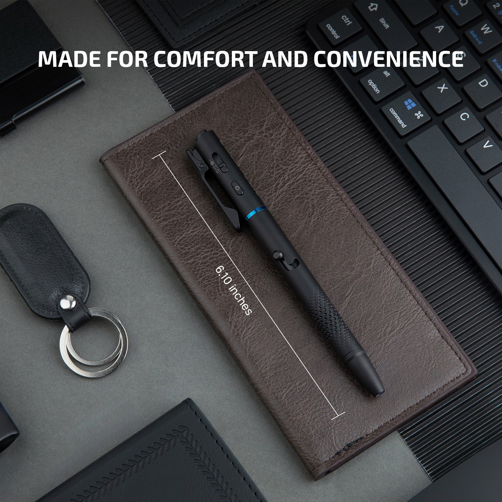 Black tactical pen with stylus, flashlight, and laser pointer, 6.10 inches long, resting on a leather notebook.